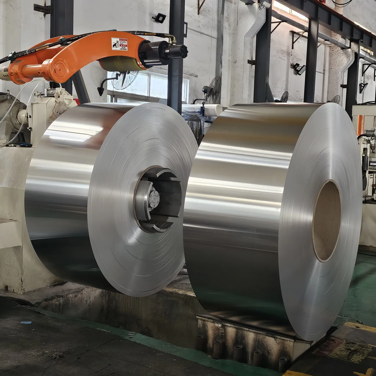 Industrial rotary slitting machine cutting precision non-magnetic stainless steel strip with tight width tolerances